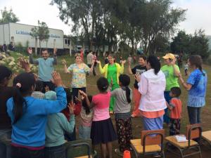 The team singing Bible songs with the children from the village